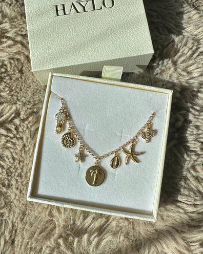 gold coastal charm necklace with ocean charms