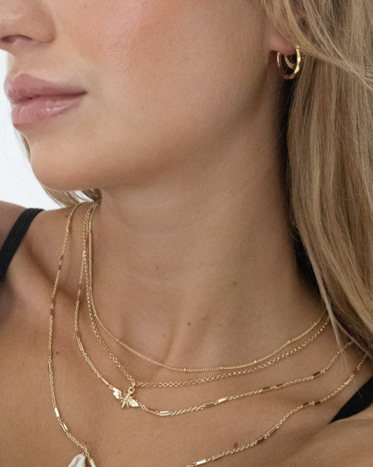 dainty gold earring stack with large hoops