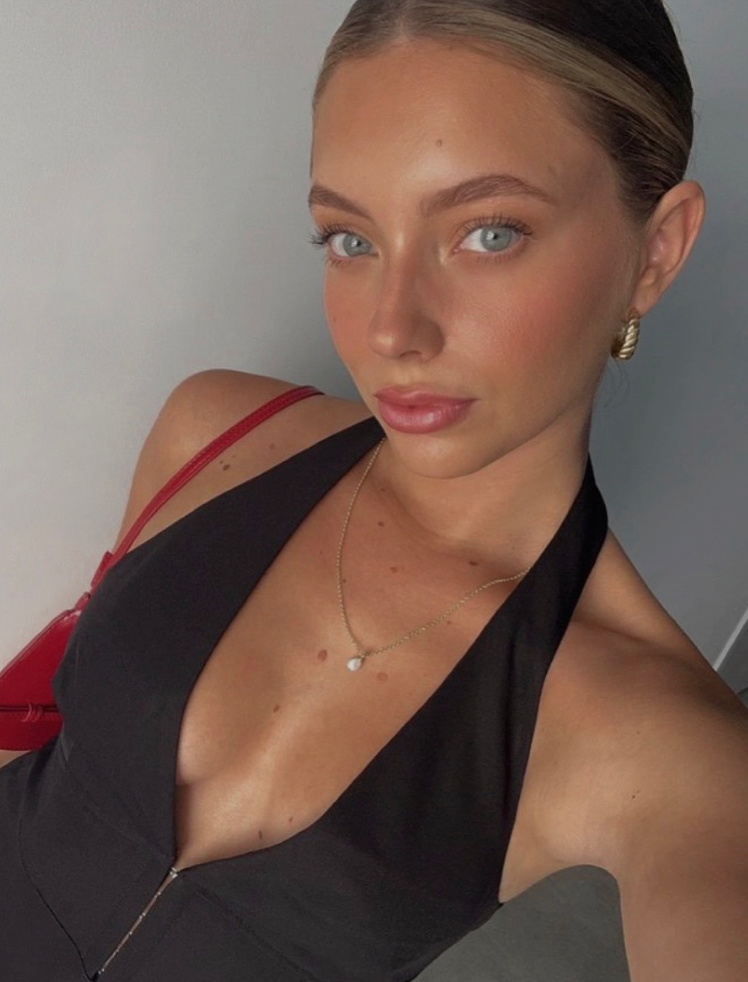 girl wearing minimalist pearl pendant gold and chunky gold hoops