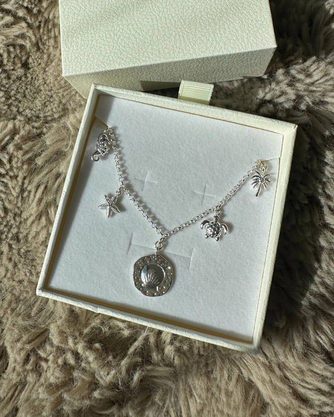 dainty silver charm necklace with silver charms