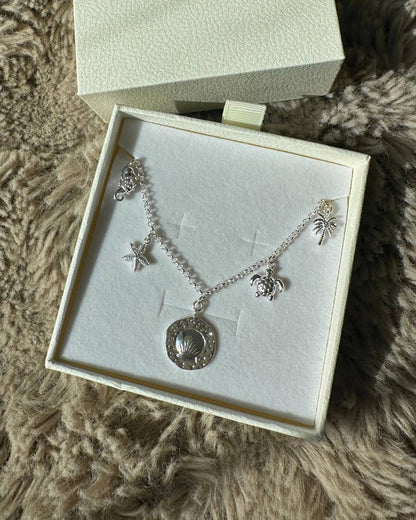 dainty silver charm necklace with silver charms