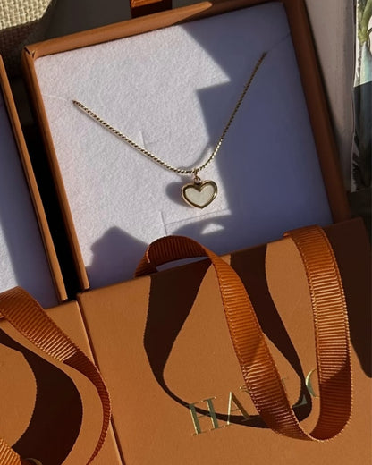 gold heart necklace with a pearl heart