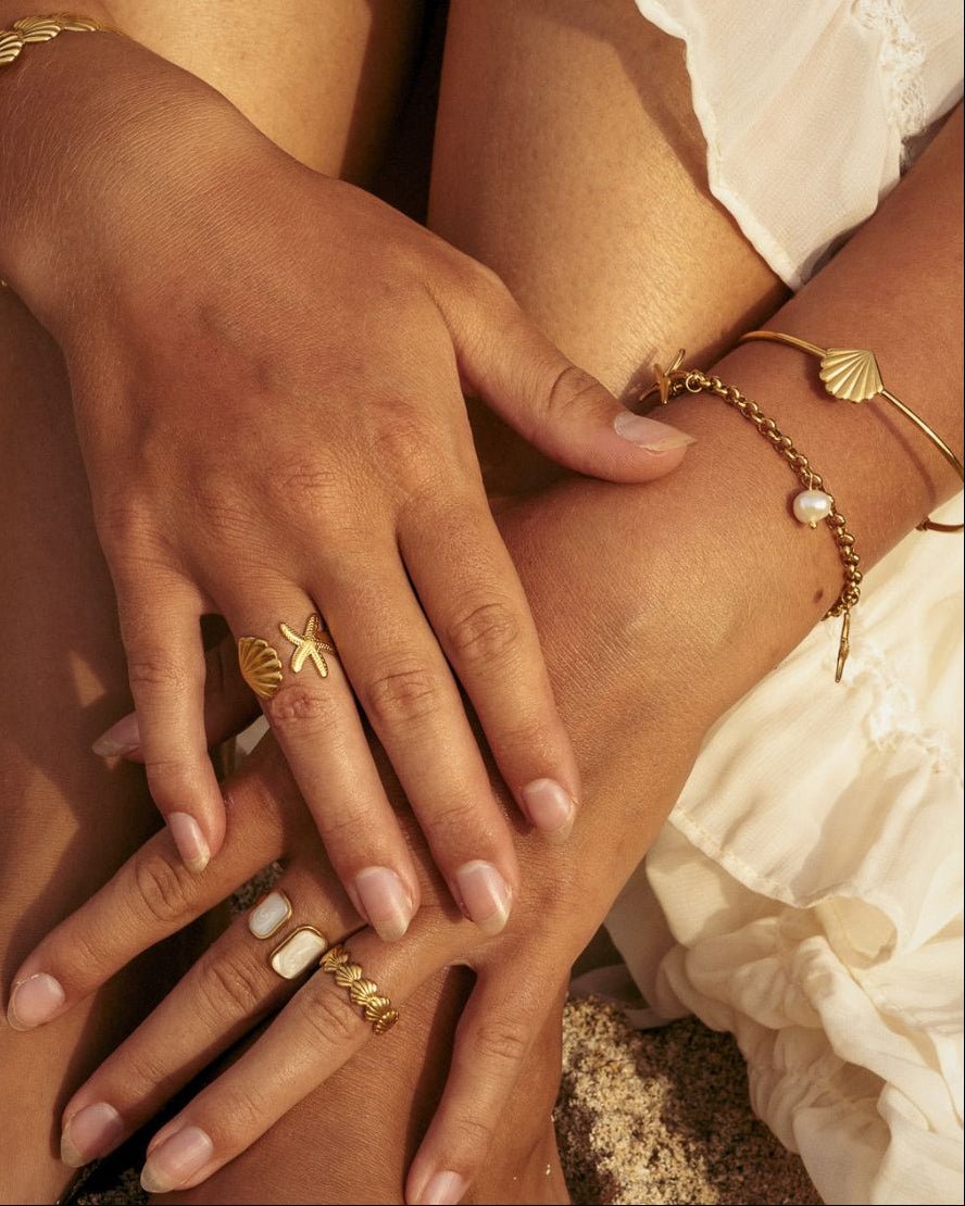 gold coastal bracelet stack with dainty Shell Bracelet Cuff and rings- Haylo & Co. Jewellery