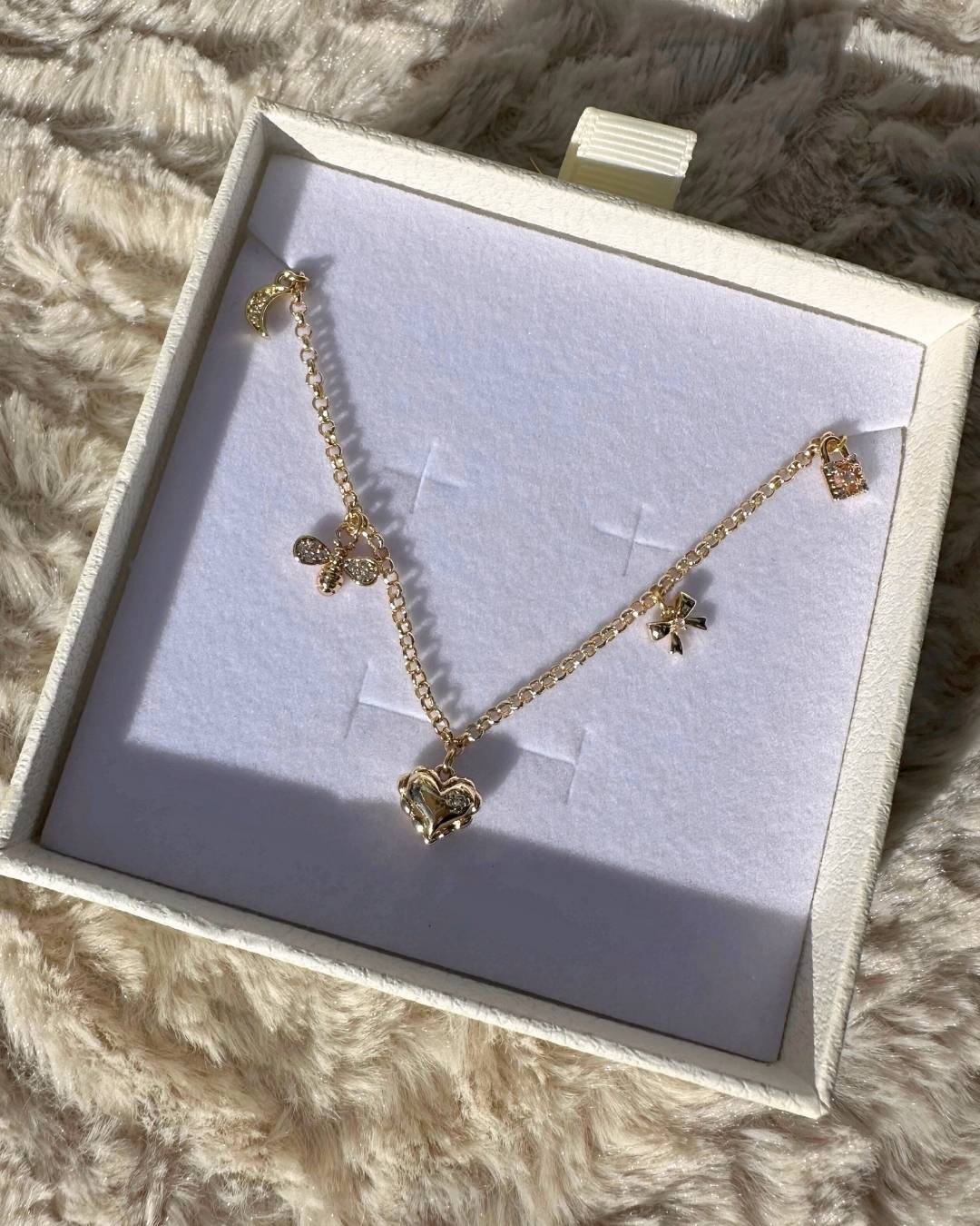 dainty gold charm necklace with mini charms